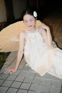 Ethereal Beauty: Woman in White Dress with Elegant Paper Umbrella at Night - image 0