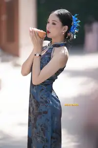 Captivating Asian Beauty: Elegant Woman in Blue Cheongsam with Traditional Fan - image 1