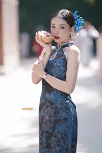 Captivating Asian Beauty: Elegant Woman in Blue Cheongsam with Traditional Fan - image 2