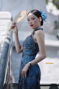 Captivating Asian Beauty: Elegant Woman in Blue Cheongsam with Traditional Fan - image 7