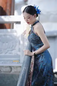 Captivating Asian Beauty: Elegant Woman in Blue Cheongsam with Traditional Fan - image 4