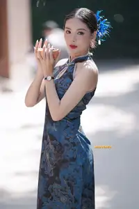 Captivating Asian Beauty: Elegant Woman in Blue Cheongsam with Traditional Fan - image 0