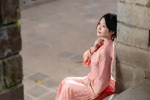 Graceful Asian Young Woman in Traditional Pink Attire: Timeless Beauty by an Ancient Wall - image 2