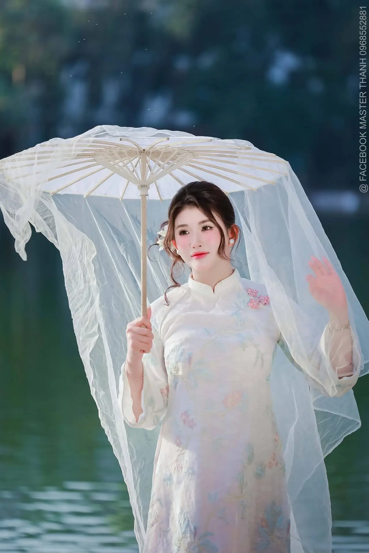 Enchanting East Asian Beauty: A Serene Muse in White Cheongsam under Soft Sunlight by the Lake.