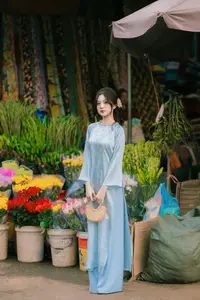 Traditional Vietnamese Beauty: Graceful Girl in Blue Ao Dai with Fresh Flowers - image 0