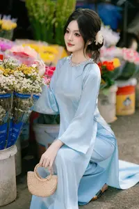 Traditional Vietnamese Beauty: Graceful Girl in Blue Ao Dai with Fresh Flowers - image 6
