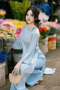 Traditional Vietnamese Beauty: Graceful Girl in Blue Ao Dai with Fresh Flowers - image 11