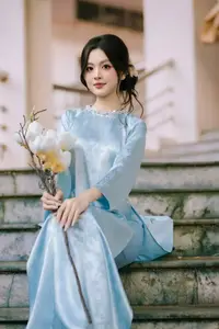 Traditional Vietnamese Beauty: Graceful Girl in Blue Ao Dai with Fresh Flowers - image 12