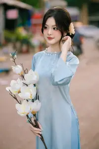 Traditional Vietnamese Beauty: Graceful Girl in Blue Ao Dai with Fresh Flowers - image 4