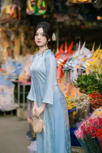 Traditional Vietnamese Beauty: Graceful Girl in Blue Ao Dai with Fresh Flowers - image 15