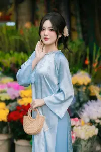 Traditional Vietnamese Beauty: Graceful Girl in Blue Ao Dai with Fresh Flowers - image 16