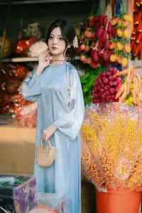 Traditional Vietnamese Beauty: Graceful Girl in Blue Ao Dai with Fresh Flowers - image 14