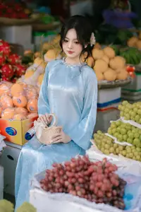 Traditional Vietnamese Beauty: Graceful Girl in Blue Ao Dai with Fresh Flowers - image 7