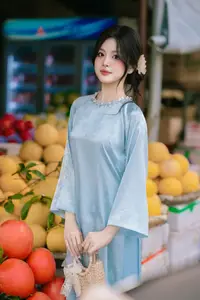 Traditional Vietnamese Beauty: Graceful Girl in Blue Ao Dai with Fresh Flowers - image 2