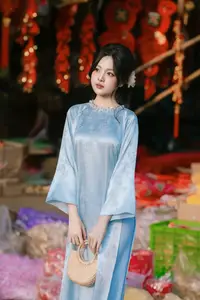 Traditional Vietnamese Beauty: Graceful Girl in Blue Ao Dai with Fresh Flowers - image 5