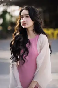 Captivating Grace: Long-Haired Beauty in Soft Pink Evokes Dreamy Serenity. - image 1