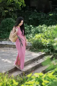 Captivating Grace: Long-Haired Beauty in Soft Pink Evokes Dreamy Serenity. - image 2
