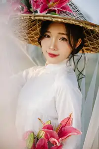 Discover the captivating grace of a Vietnamese woman in a flowing white Ao Dai and traditional conical hat - image 21