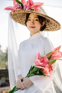 Discover the captivating grace of a Vietnamese woman in a flowing white Ao Dai and traditional conical hat - image 1