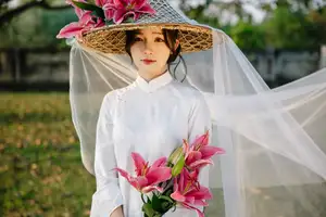 Discover the captivating grace of a Vietnamese woman in a flowing white Ao Dai and traditional conical hat - image 23