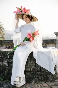 Discover the captivating grace of a Vietnamese woman in a flowing white Ao Dai and traditional conical hat - image 25