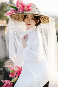 Discover the captivating grace of a Vietnamese woman in a flowing white Ao Dai and traditional conical hat - image 18