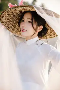 Discover the captivating grace of a Vietnamese woman in a flowing white Ao Dai and traditional conical hat - image 12