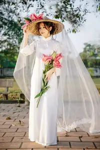 Discover the captivating grace of a Vietnamese woman in a flowing white Ao Dai and traditional conical hat - image 15