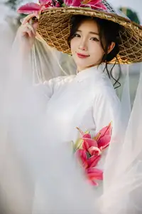 Discover the captivating grace of a Vietnamese woman in a flowing white Ao Dai and traditional conical hat - image 24