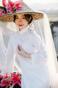Discover the captivating grace of a Vietnamese woman in a flowing white Ao Dai and traditional conical hat - image 5