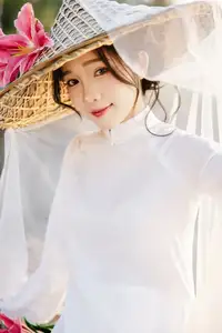 Discover the captivating grace of a Vietnamese woman in a flowing white Ao Dai and traditional conical hat - image 13