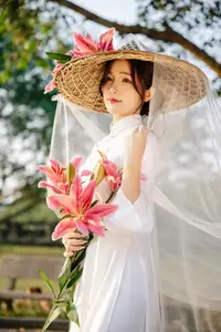 Discover the captivating grace of a Vietnamese woman in a flowing white Ao Dai and traditional conical hat - image 22