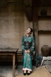Elegant Asian Beauty: Serene Woman in Modernized Traditional Dress with Vintage Floral Vase - image 2