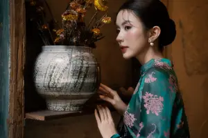 Elegant Asian Beauty: Serene Woman in Modernized Traditional Dress with Vintage Floral Vase - image 3
