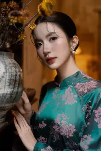 Elegant Asian Beauty: Serene Woman in Modernized Traditional Dress with Vintage Floral Vase - image 9