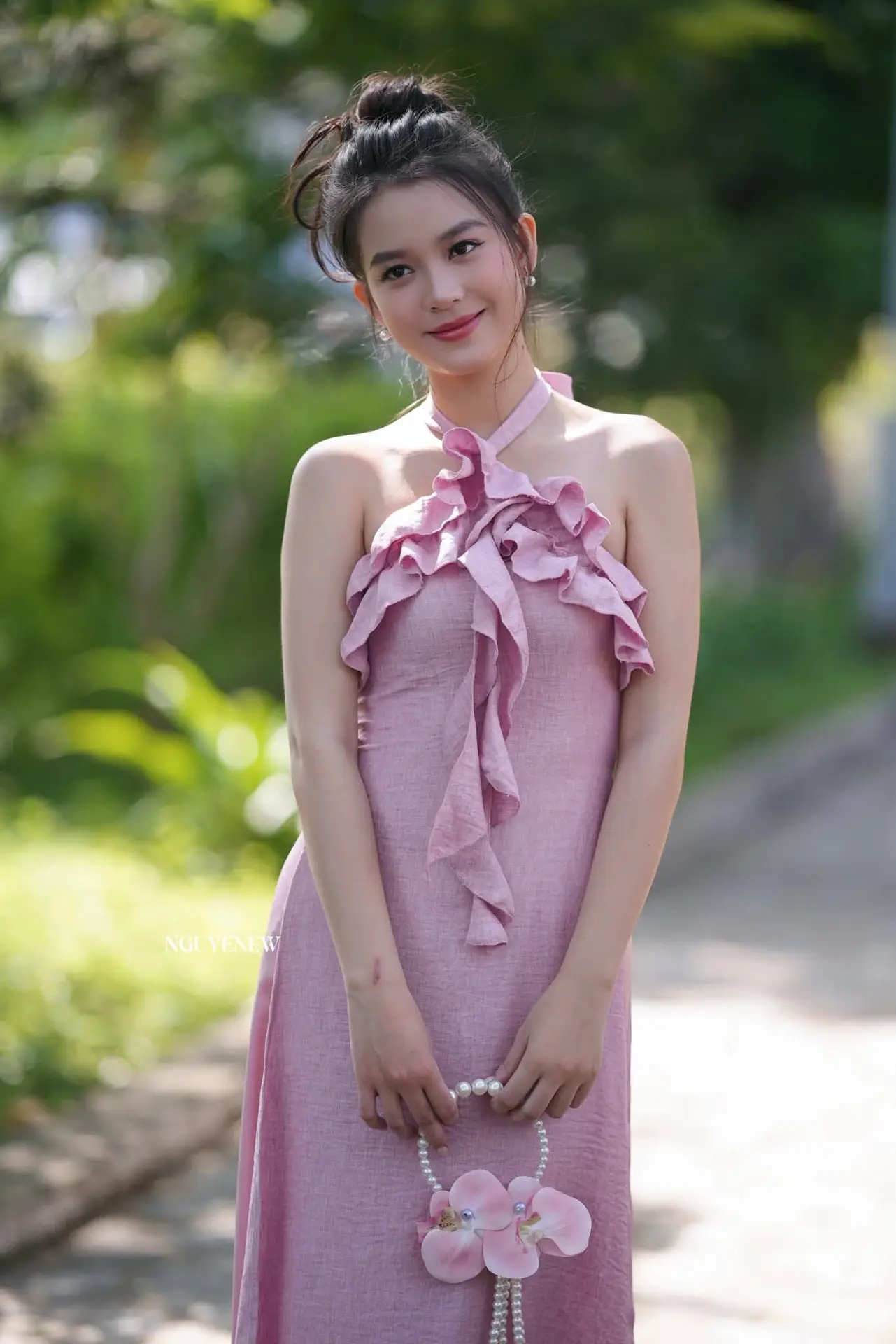 Gentle Charm: A Girl in an Elegant Pink Dress Amidst Nature's Embrace