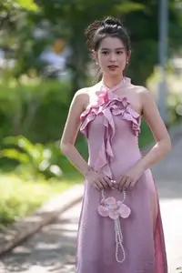 Gentle Charm: A Girl in an Elegant Pink Dress Amidst Nature's Embrace - image 4