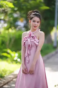 Gentle Charm: A Girl in an Elegant Pink Dress Amidst Nature's Embrace - image 3