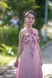 Gentle Charm: A Girl in an Elegant Pink Dress Amidst Nature's Embrace - image 2