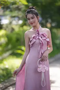 Gentle Charm: A Girl in an Elegant Pink Dress Amidst Nature's Embrace - image 1