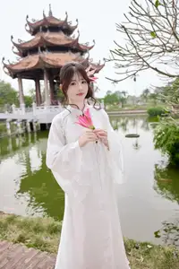 Elegant White Ao Dai with Pink Lotus Flower Embracing Cultural Heritage - image 3