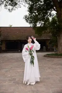 Elegant White Ao Dai with Pink Lotus Flower Embracing Cultural Heritage - image 0