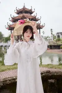 Elegant White Ao Dai with Pink Lotus Flower Embracing Cultural Heritage - image 11