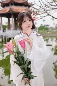 Elegant White Ao Dai with Pink Lotus Flower Embracing Cultural Heritage - image 2