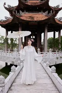 Elegant White Ao Dai with Pink Lotus Flower Embracing Cultural Heritage - image 6