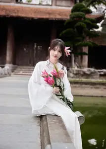 Elegant White Ao Dai with Pink Lotus Flower Embracing Cultural Heritage - image 1