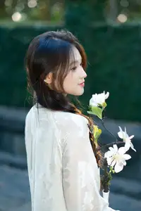 Pure Charm: White-Dressed Girl Winking Playfully with White Flowers 1000024585 - image 4