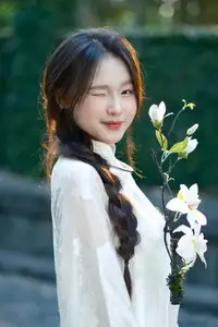 Pure Charm: White-Dressed Girl Winking Playfully with White Flowers 1000024585 - image 2