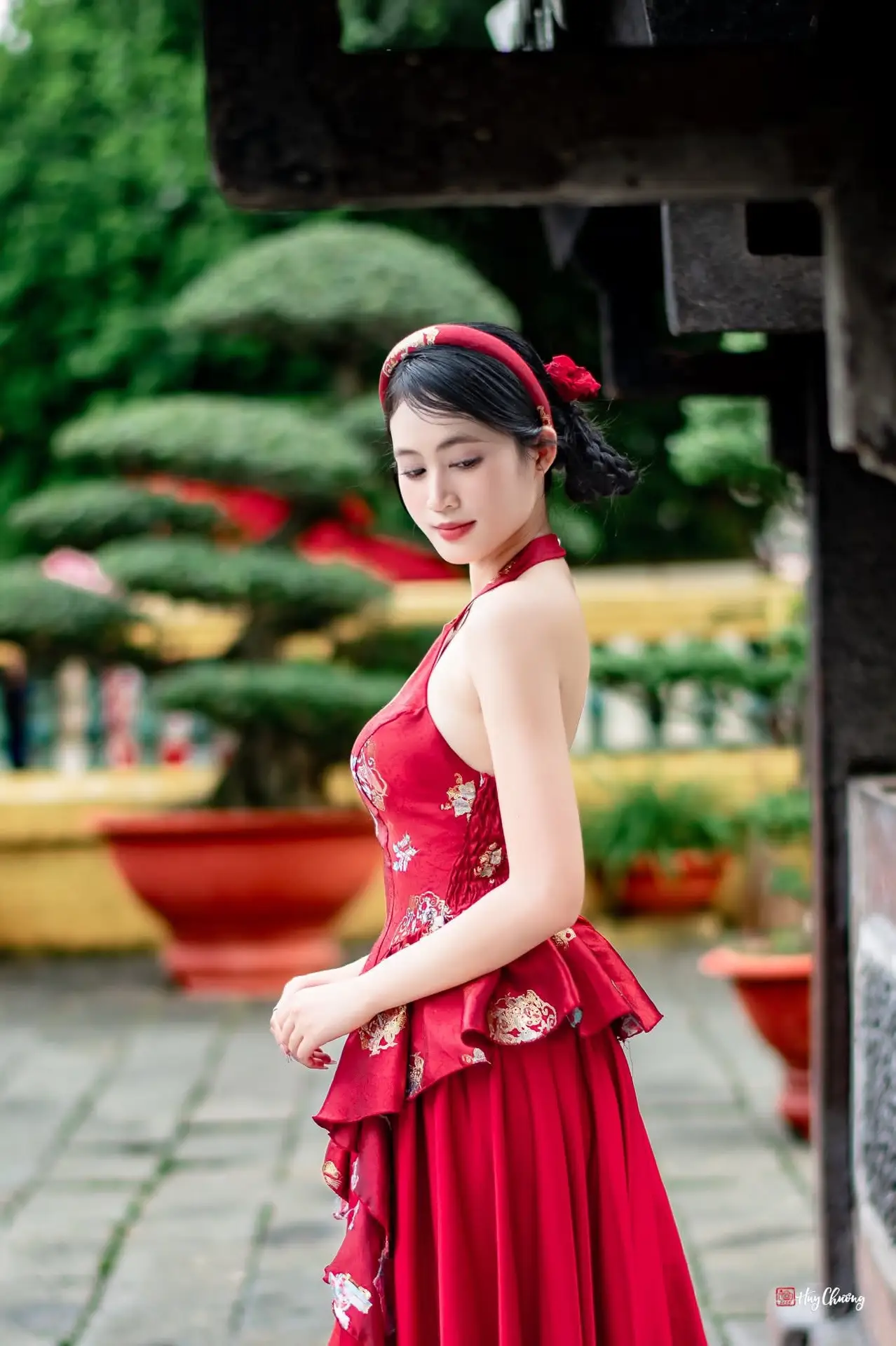 Elegant Asian Beauty in Red Dress Shines Gracefully Amidst a Traditional Garden 1000024509