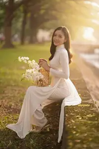 Serene Vietnamese Beauty in White Ao Dai Bathed in Golden Sunset Light - image 0